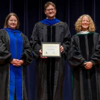 Awardee posing with Christine and Provost Drake